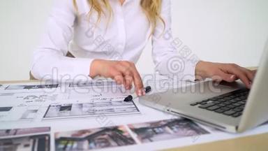 女建筑师在她的办公室工作，从事新的项目；手工图纸，计算机图纸。